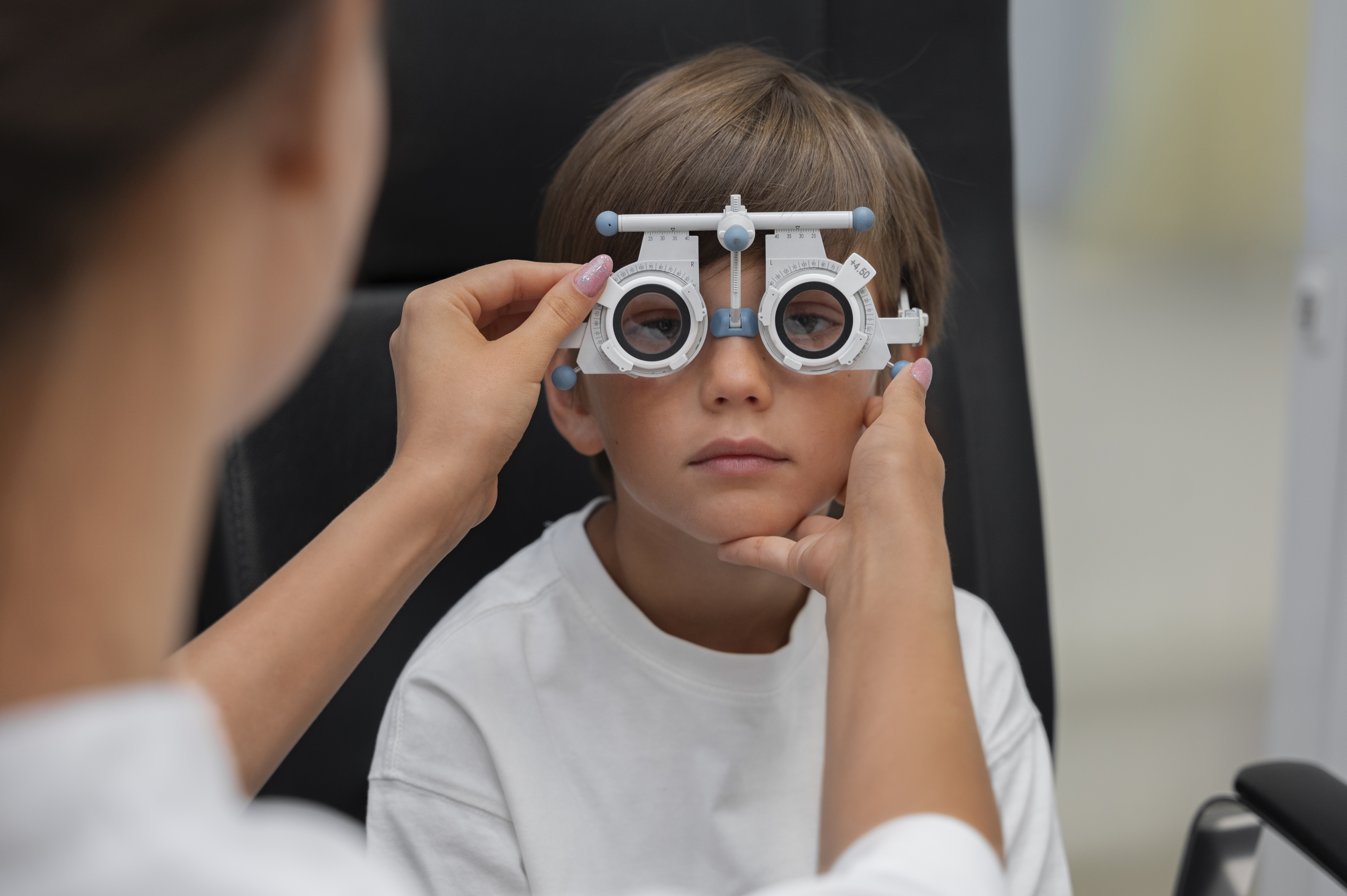 A young boy undergoes an eye examination to assess his vision and determine if he needs glasses